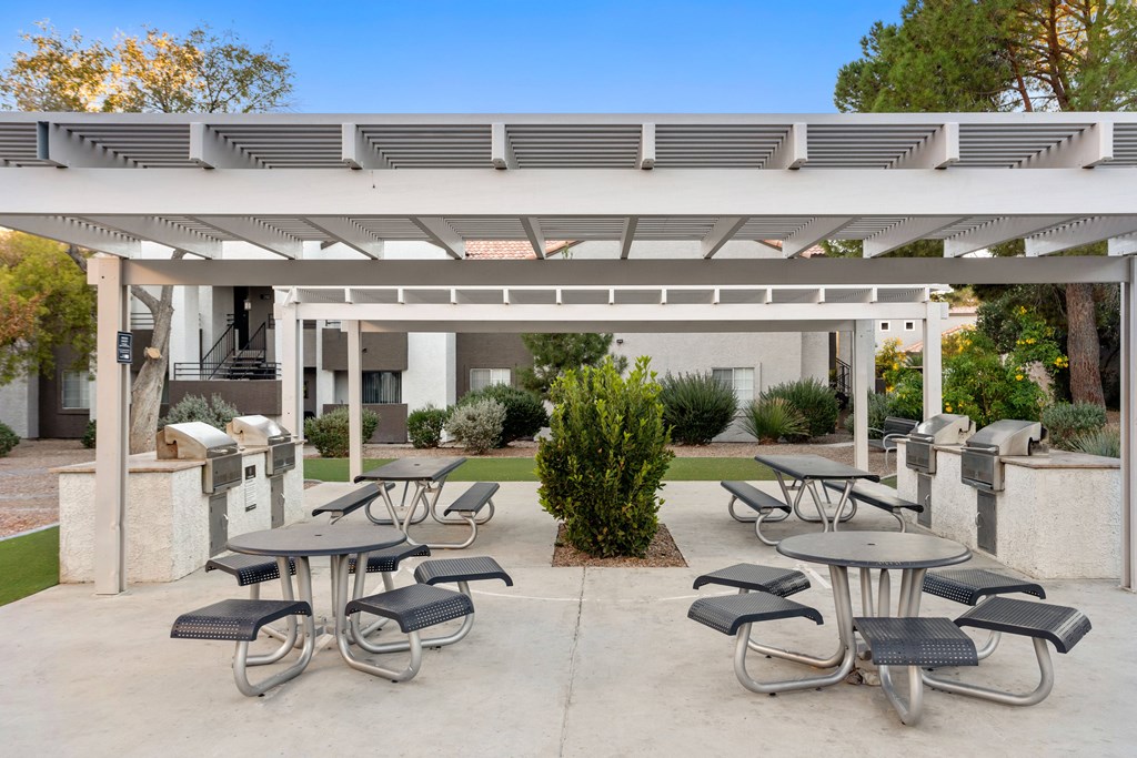 an outdoor patio with tables and chairs